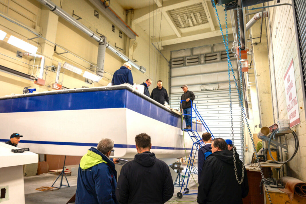 large boat in enclosure with workers